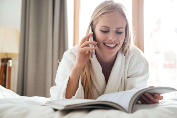 Young, blond woman practicing her Swedish accent on the phone
