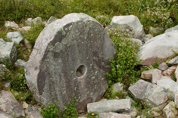 Piedras cansadas, "tired stones", remain in the Incan Quarry. The quarry (Cachiccata in Quechua, Las Canteras in Spanish) was where the stones to build Ollantaytambo were hewn from landslide boulders and carted over 7pm downhill to the town and fort. Most stones were dozens or even hundreds of tons making the proposed dragging route extremely difficult.  Now the obvious question is what is this wheel doing here. The Incas did not apparently have or use the wheel at any time. Yet this very large, very wheel-like circle remains standing in the quarry. One idea is that it was a late build after the Spanish had arrived and introduced new ideas (Ollaytaytambo appears to have been still being built or rebuilt when the Spanish attacked the final time from Cusco). Or perhaps it truly was something not a wheel and the hole in the centre not for an axle. Weird either way and archeological theories about the site are hard to come by.  While mainstream archeology believes the quarry-and-drag theory to be standard, many mysteries abound as to how the quarry worked. Large-scale evidence of geoengineering to widen and flatten the rough walking trail down appears missing. My friend pointed out another big question: where are all the rock chips and bits left over from the shaping and cutting? Much might have be washed downhill or buried, but such an industrious site would surely leave traces archeologists could find in the layers. To my knowledge, such tests haven't been made.