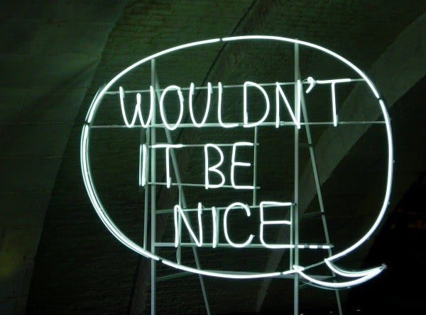 Neon sign that says "Wouldn't it be nice" referring to being bilingual.