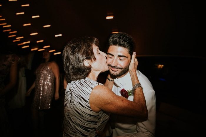 Woman kissing a man on the cheek at a disco