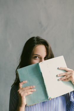 A woman reading book to learn Polish