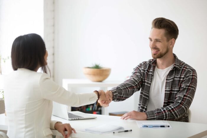 Man and woman greeting each other in German