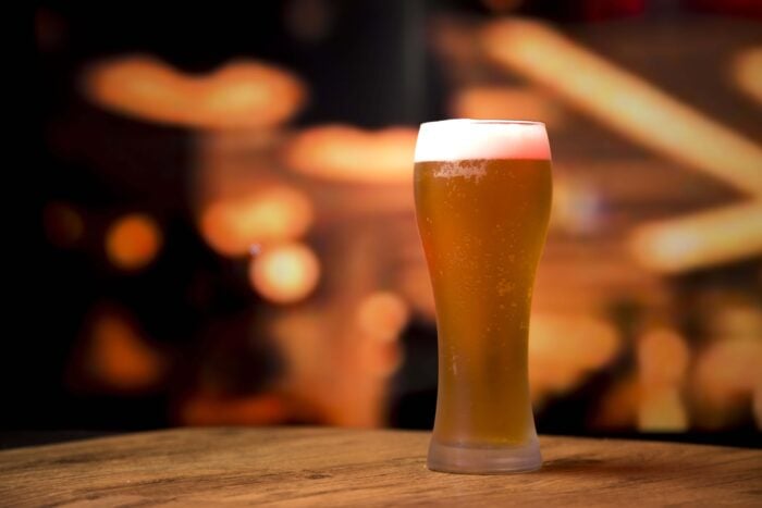 A small beer, also known as fino or imperial in Portuguese slang, with a blurred background.