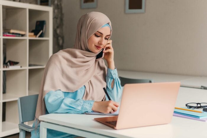 Arab woman talking on the phone and setting a date