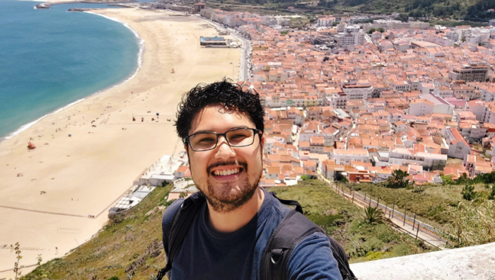 A young man smiling on the beach