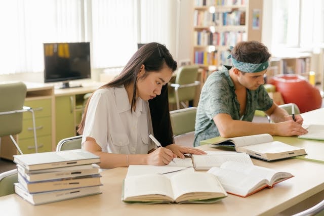 Two students taking notes