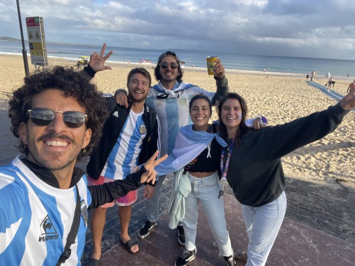 A group of Argentine friends cheering for their soccer team at the World Cup