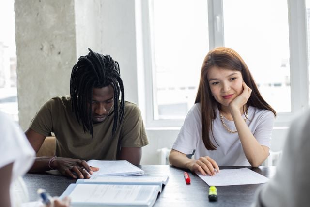 Students attending a Korean language lesson and taking notes in class.