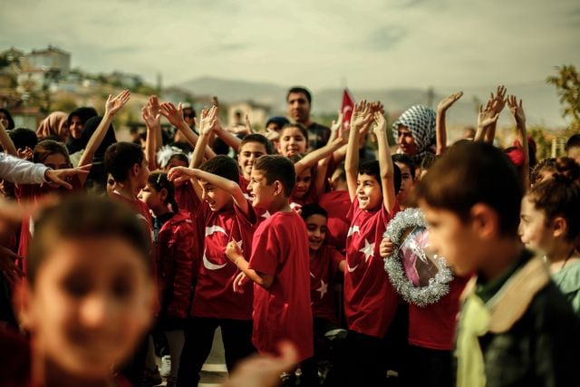 Turkish children celebrating together at a community event, showing warmth and social connection.