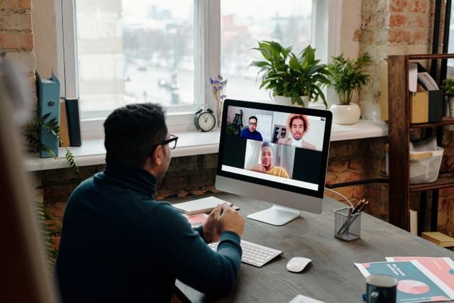 Employee joining a video call from a home office, illustrating language training for remote global teams.