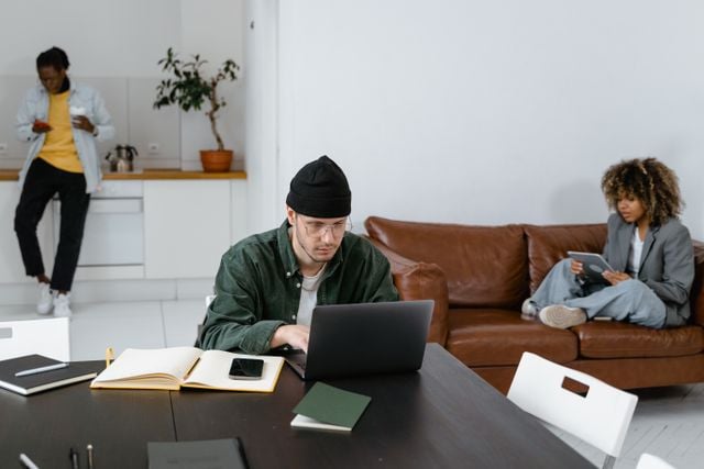 Professionals collaborating in an office setting, reflecting workplace learning formats such as in-person or blended corporate language training.